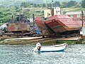 Slipway at Portland Harbour, Dorset, England, holding a split dump barge (on right)