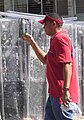 Closeup of a Man in front of riot shields