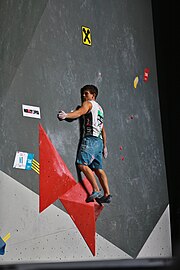 A climber using the smearing technique on an indoor climbing wall