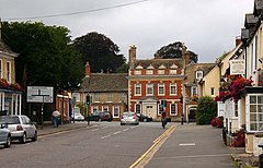 Traffic junction with Queen Anne redbrick house beyond