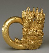 Gold spiral with double lion-griffin-head terminal MET GR563.jpg