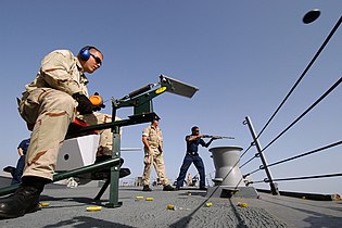 Swing arm trap launching a clay