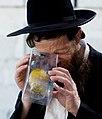 Man in Mea Shearim inspecting etrog