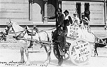 This is a photograph of students on horse cart taking part in the annual Prosh event IN 1905, poking fun at Nobel Prize laureates Bragg and Bragg. A poster reads "Do not Bragg about radium".