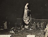 Students dancing around Statue of Industry after tarring and feathering it