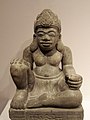 This seated figure may be a dharmapala. The pedestal below (not pictured) features an image of a kala head.