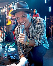 Bruno Mars kneeling down