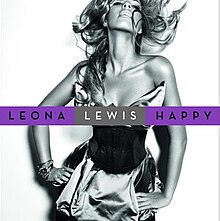 A black and white portrait of a woman. She has a long wavy hair and she is smiling, also she has her hands on her waist. She wears a cocktail dress and many bracelets on her right wrist. In front of her image the words "Leona" and "Happy" are written in black capital letters and inside a purple box, while "Lewis" is in white capital letters appearing in a silver box.