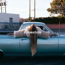 Cover art for "Formation": Beyoncé in a blue pickup truck, her arms outstretched and upper half sticking out the window, most prominently, her cornrows hairstyle