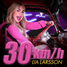 Larsson dressed in bright pink inside of a car and smiling at the camera