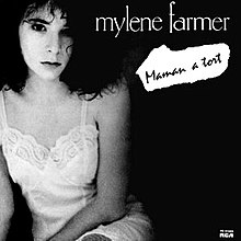 Photo depicting at the left Mylène Farmer who is wearing a white nightgown, on a black background