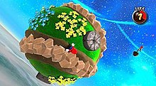 In this screenshot, Mario is running across a small, circular planetoid in outer space. The game has gravity mechanics which allows Mario to run upside down or sideways.