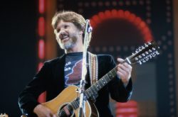 Kris Kristofferson, US country singer and actor, playing the guitar on stage during a live concert performance at the International Festival of Country Music, at Wembley Arena, London, England, United Kingdom, in April 1982. (Photo by Keystone/Hulton Archive/Getty Images)