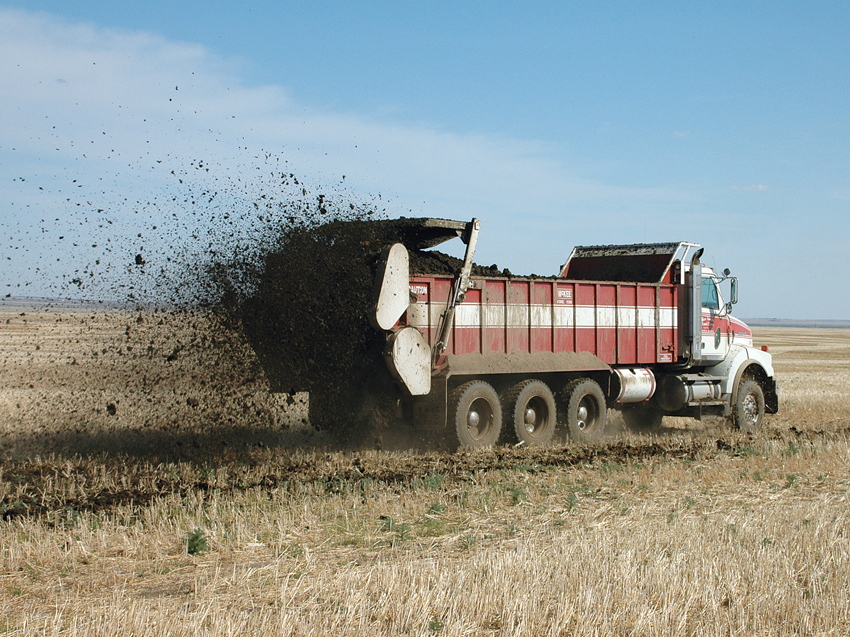 Tractor spreading manure on fields