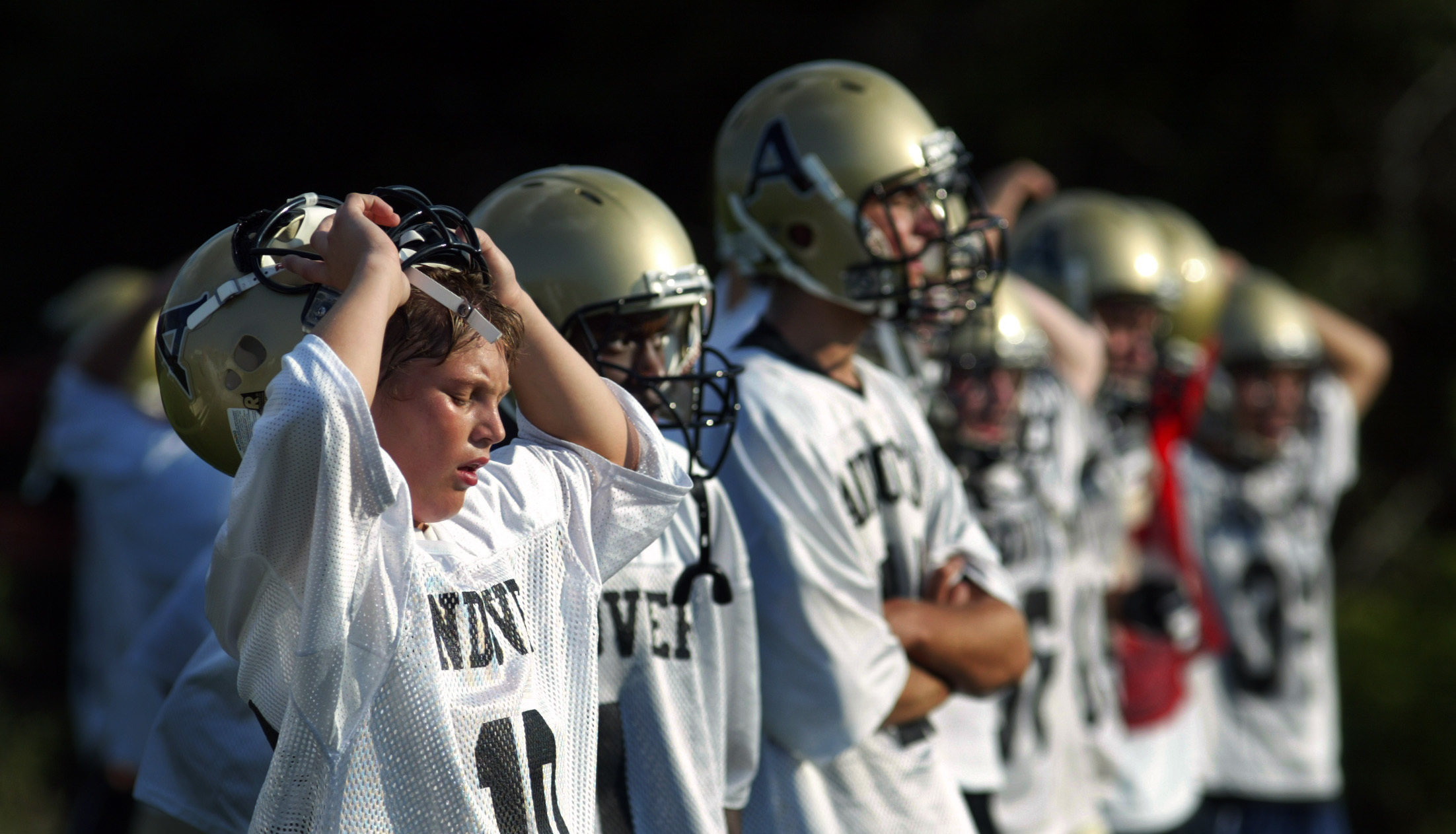 Offensive player J.T. Evans, left, and teammates worked up a sweat after running back and forth across the football field at Andover High School Monday on the first day of practice. Those who couldn’t run fast enough had to make a few extra laps and hear