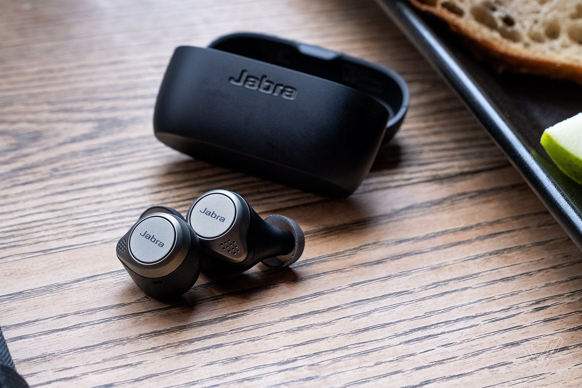 Jabra’s Elite 75t, the best wireless earbuds for multitasking, pictured on a table.