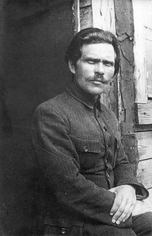 Portrait photograph of Nestor Makhno wearing a dark suit and a moustache