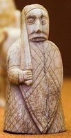 Different rook pieces from the Lewis chessmen, depicted as a warrior biting his shield.