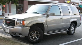 GMT400 GMC Yukon Denali (left) was nearly identical to the Cadillac Escalade (right).