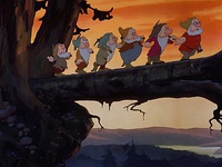 December 21: Walt Disney's Snow White and the Seven Dwarfs is released, the world's first full-length animated feature film, the first Disney film, and the first film to feature a Disney Princess. The top image shows the Seven Dwarfs singing "Heigh-Ho" while walking on a log. The second top image shows Walt Disney introducing the Seven Dwarfs in the trailer and the bottom images are the trailers.