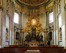 Pews before the ornate, gold-leafed throne of St. Peter