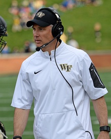 Dave Clawson coaching in a white shirt and hat.