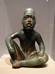 Seated shaman in ritual pose-shaped pendant (Olmec); 9th-5th century BC; serpentine and cinnabar; height: 18.5 cm; Dallas Museum of Art (Dallas, Texas, US)[60]