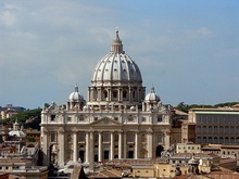 Photo. The façade is wide and has a row of huge columns rising from the basement to support the cornice. The ribbed, ovoid dome is surmounted by a lantern topped with ball and cross. Its drum is framed by two very much smaller domes.