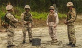 Royal Bermuda Regiment Guns and Assault Pioneers Platoon soldiers and a US Marine discuss training at Camp Lejeune in 2013.