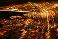 Taken aboard an airplane turning above San Jose at night. The city lights form concentric strips.