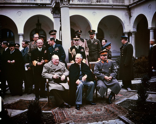 From left to right: Winston Churchill, Franklin D. Roosevelt, and Joseph Stalin. Also present are British Foreign Minister Anthony Eden and Soviet Foreign Minister Vyacheslav Molotov (far left); Field Marshal Sir Alan Brooke, Admiral of the Fleet Sir Andrew Cunningham, RN, Marshal of the RAF Sir Charles Portal, RAF, (standing behind Churchill); General George C. Marshall, Chief of Staff of the United States Army, and Fleet Admiral William D. Leahy, USN (standing behind Roosevelt).