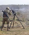 A soldier with the Ukrainian Land Forces fires a DShKM