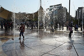 Children's water play in the fountains of the park.