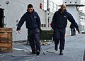 Sailors carrying box of ammunition