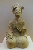 An Eastern Han ceramic figurine of a seated woman with a bronze mirror, unearthed from a tomb of Songjialin, Pi County, Sichuan