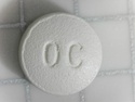 Both sides of a single 10mg OxyContin pill.