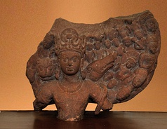 A terracotta statue of Vishnu Caturanana ("Four-Armed"), using the attributes of Vāsudeva-Krishna, with the addition of an aureole around the head (5th century CE). Uttar Pradesh.[20]