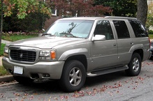 GMT400 GMC Yukon Denali (left) was nearly identical to the Cadillac Escalade (right).