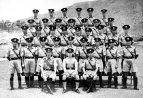 Police officers in summer uniform in 1954. Everything, except for the shorts, was used until 2005 (left), Hong Kong Police Pipe Band performance in Government House (right)