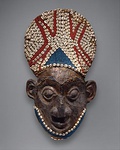 Royal mask; by artists of the Bamum people (Cameroon); before 1880; wood, copper, glass beads, raffia and shells; height: 66 cm; Metropolitan Museum of Art[99]