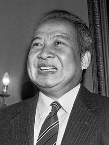 Sihanouk smiling in a black-and-white photograph