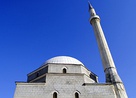 From top to bottom, left to right: The Sinan Pasha Mosque, the Roman Catholic Cathedral of Our Lady of Perpetual Succour, Gazi Mehmet Pasha Mosque, and the Serbian Orthodox Our Lady of Ljeviš church.