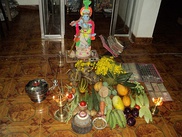 A home shrine with offerings at a regional Vishu festival (left); a priest in a temple (right)