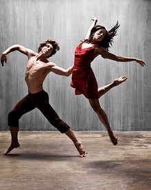 A man and woman, mid-leap