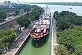 Left: MV Star Amber at the lock gate of Netaji Subhas Dock (NSD). Center: Aerial View of Netaji Subhas Dock and Hooghly River. Right:MV Kota Rakyat unloading containers at the Netaji Subhash Dock of Kolkata Dock System.