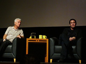 Reznor (right) discussing his return to major labels at an October 2012 panel with David Byrne