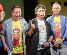 An image of the three integral staff who worked on the game: director Takashi Tezuka, producer Shigeru Miyamoto, and composer Koji Kondo.