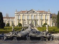 The front façade of the Queluz National Palace with ornate water fountain