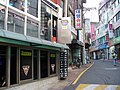 A view of "Aragon Alley" where most of the establishments are bars, note the open door on the second floor.