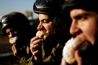 Israeli soldiers enjoying sufganiyot as part of their Hanukkah festivities.